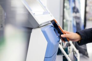 Woman scanning via mobile phone and machine